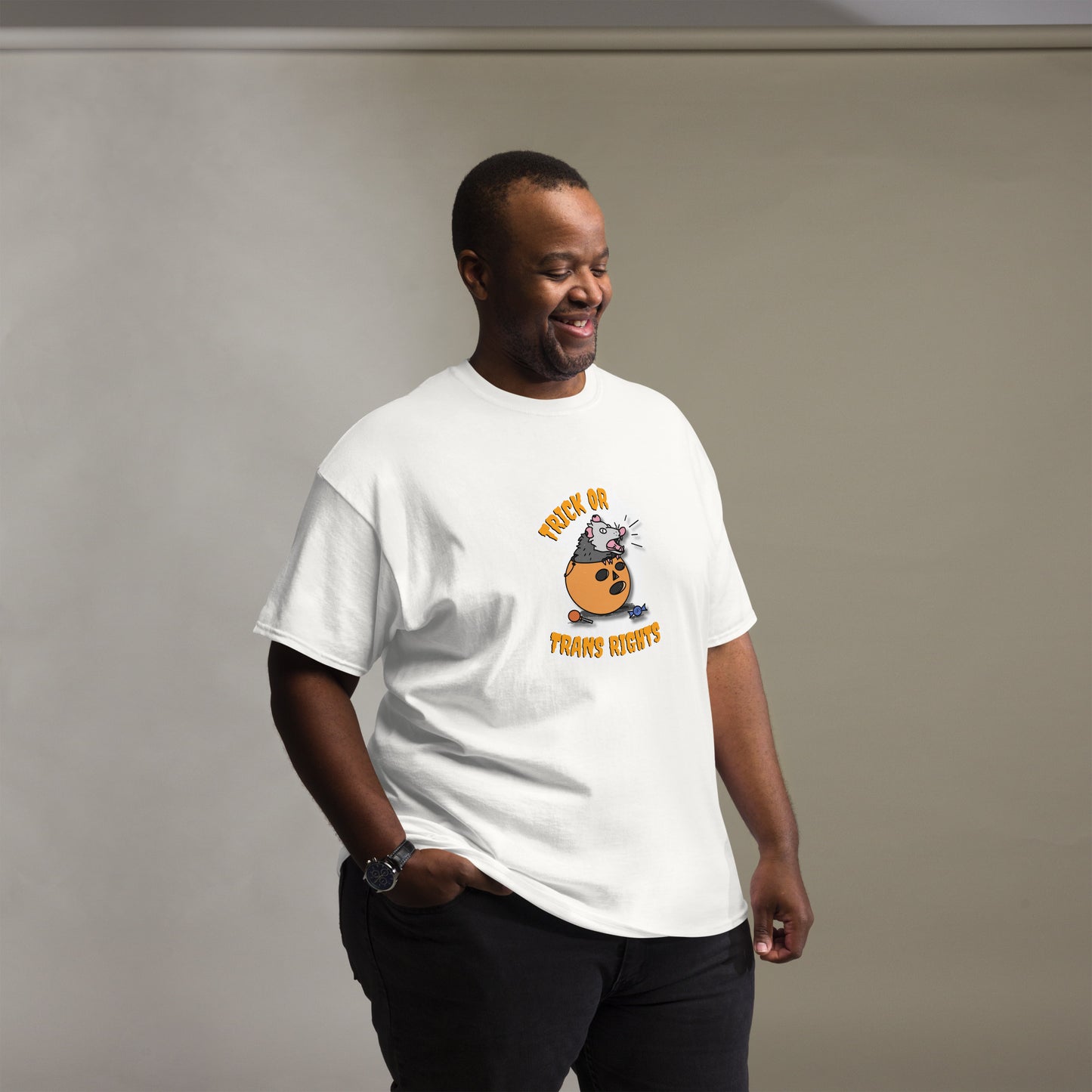 This design features a possum in an orange plastic candy bucket with the text "Trick or Transphobia" on a white t-shirt . This image is shirt design on a plus-sized model.