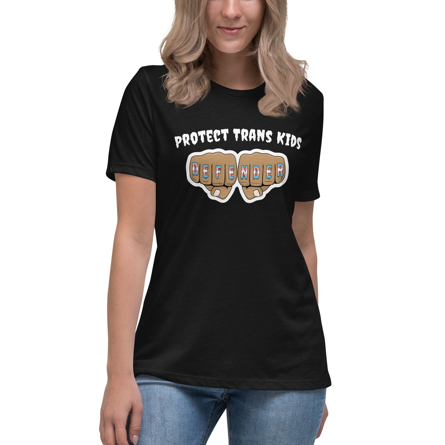 A standard, round neck, short sleeve t-shirt in black with the text "protect trans kids" in white lettering above an image of fists with "defender" written across the knuckles in blue,pink, and white. The shirt is on a white, straight sized model standing against a white background.