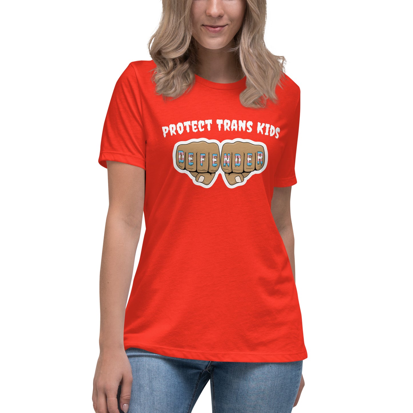 A standard, round neck, short sleeve t-shirt in orange with the text "protect trans kids" in white lettering above an image of fists with "defender" written across the knuckles in blue,pink, and white. The shirt is on a white, straight sized model standing against a white background.
