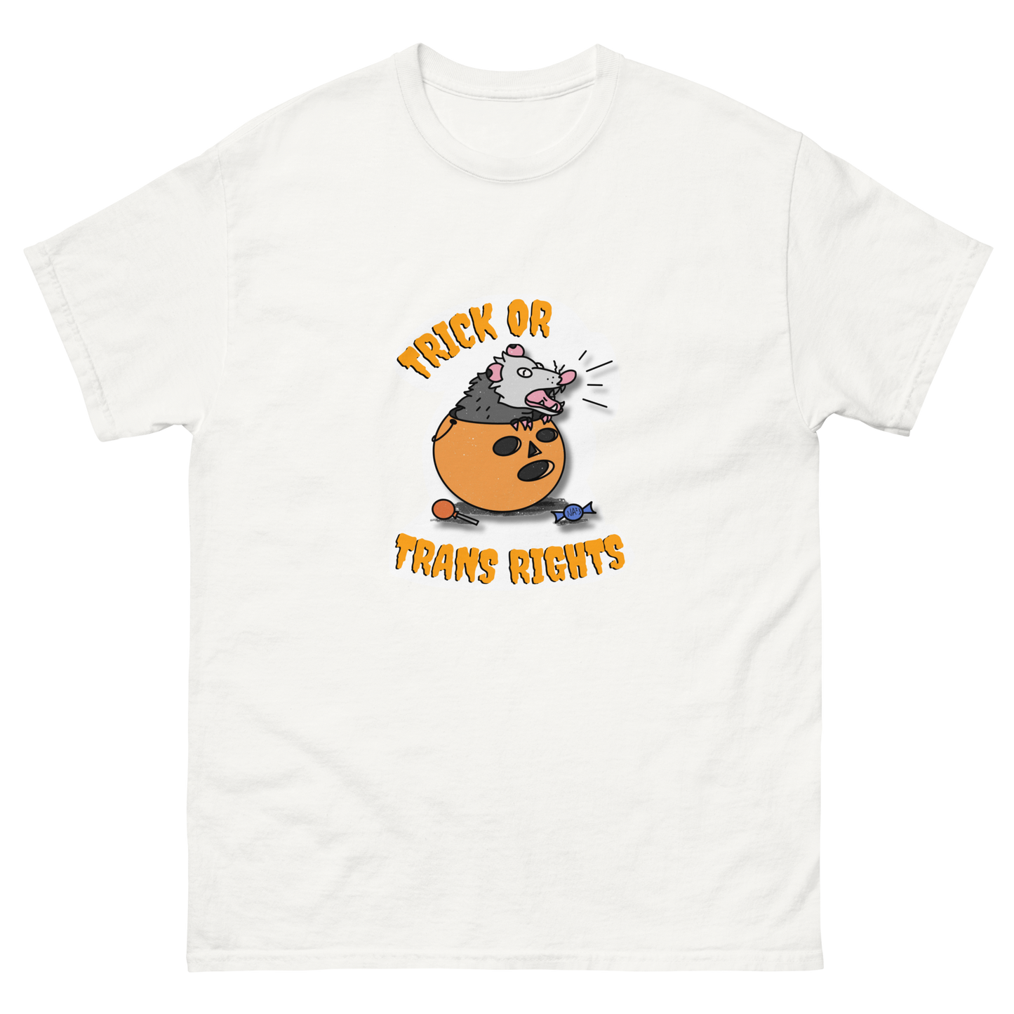 This design features a possum in an orange plastic candy bucket with the text "Trick or Transphobia" on a white t-shirt. This image is the shirt design laid flat.