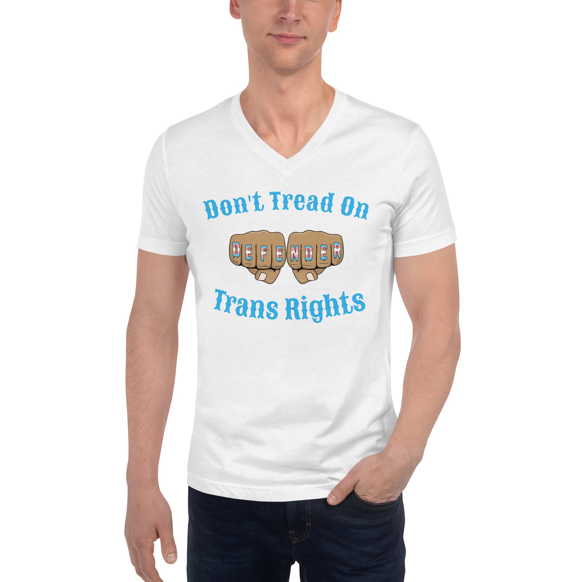 A v-neck, short sleeve t-shirt in white with the text "Don't Tread on Trans Rights" in blue lettering circling an image of fists with "defender" written across the knuckles in blue, pink, and white. The shirt is on a white, straight sized model standing against a white background.
